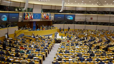 The-hemicycle-during-a-plenary-session-in-the-European-Parliament-in-Brussels,-Belgium---Tilt-up-shot