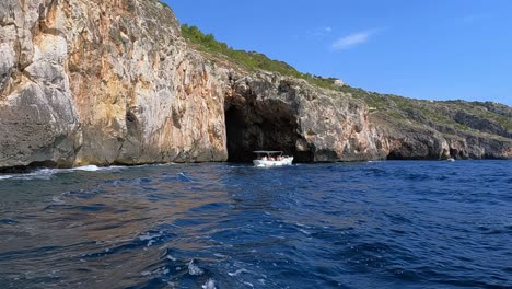 Tourists-aboard-motorboat-for-tour-at-Punta-Meliso-where-Ionian-and-Adriatic-seas-meet