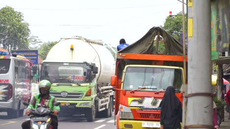 Slow-motion-video-of-busy-highway-passing-vehicles-with-truck-parking-on-the-side