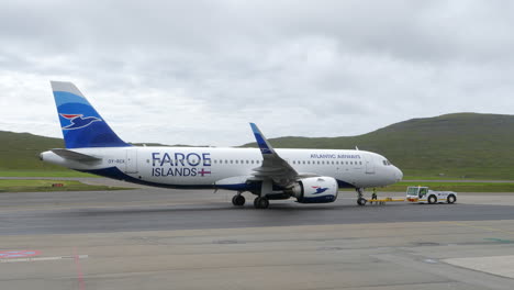 Atlantic-Airways-plane-at-Vagar-Airport-on-cloudy-day,-Faroe-Islands