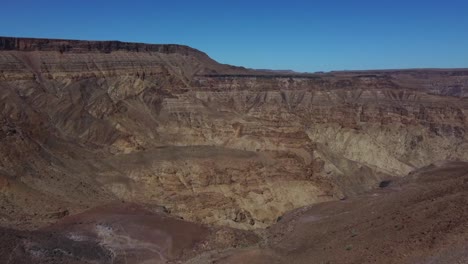 Drone-shot-of-the-Fish-River-Canyon-in-Namibia---drone-is-flying-through-the-hills-of-the-African-canyon