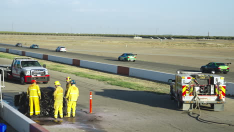 Firefighters-examining-the-burnt-sports-car