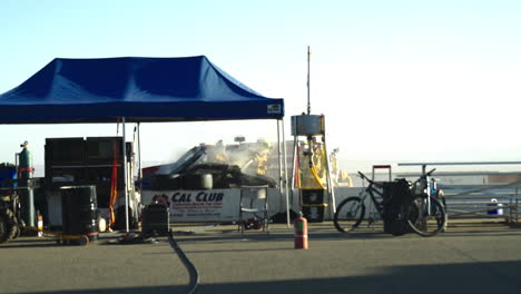 Slow-motion-of-firefighters-extinguishing-race-car-after-explosion