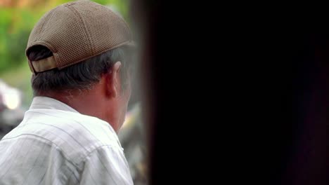 Slow-motion---Close-up-shot-of-poor-man-sit-on-the-side-of-road-than-holding-head