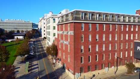 Reverse-Aerial-of-Piedmont-Leaf-Lofts-in-downtown-Winston-Salem,-NC