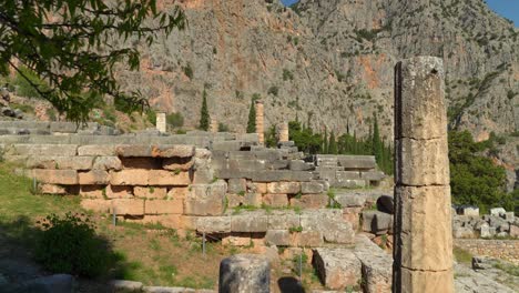 Antigua-Columna-De-Mármol-De-Piedra-Del-Sitio-Arqueológico-De-Delfos-Con-Alta-Montaña