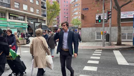 People-crossing-the-street-at-the-crosswalk-in-Madrid-city-center,-Spain