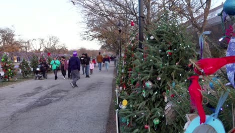 Multi-Ethnic-Group-of-People-Enjoying-Brightly-Colored-Xmas-Tree-decorations