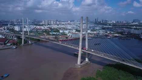 Aerial-view-of-Phu-My-Bridge-over-Saigon-river-with-road-and-river-transportation-on-a-sunny-day