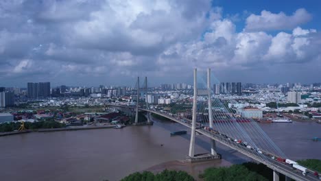 Aerial-view-of-Phu-My-Bridge-over-Saigon-river-with-road-and-river-transportation-on-a-sunny-day