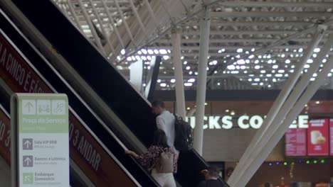 slow-motion-shot-of-travelers-going-up-the-escalator-in-brasilia-airport