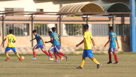 Close-up-shot-of-kids-playing-football-in-the-ground-of-Karachi