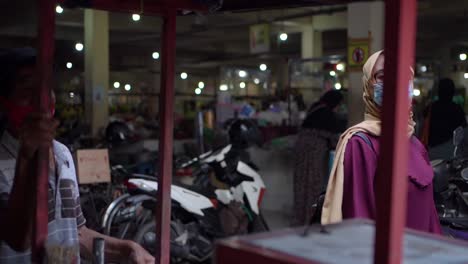 a-beautiful-woman-on-vacation-passes-a-meatball-seller-or-cilok-in-the-carts