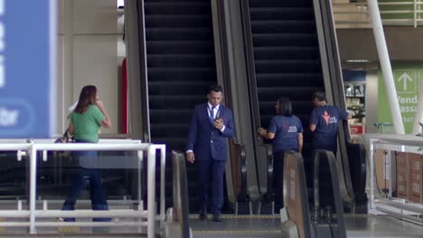 Toma-En-Cámara-Lenta-De-Los-Funcionarios-Del-Aeropuerto-En-Las-Escaleras-Mecánicas-Durante-Su-Trabajo-En-Brasilia-International