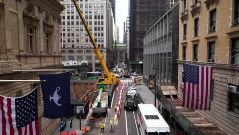 Aerial-view-of-construction-workers-and-heavy-machinery-in-middle-of-Manhattan,-New-York-city