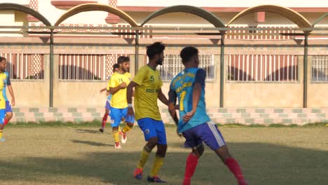 Close-up-shot-of-teenager-playing-football-in-the-ground-of-Karachi