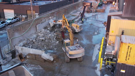 Brooklyn-NYC-USA,-Aerial-View-of-Tracked-Loader-and-Excavator-Drilling-Machines-on-Demolition-Site,-Drone-Shot