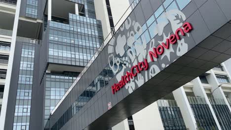 Tilt-up-panning-view-of-the-building-exterior-of-the-new-HealthCity-Novena-Medical-Hub-in-Tan-Tock-Seng,-Singapore