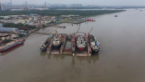 Fly-in-to-aerial-view-of-ships-being-repaired-in-dry-dock