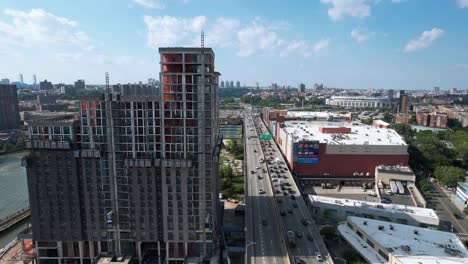 Aerial-view-traffic-on-Major-Deegan-Expressway,-in-sunny-Bronx,-New-York,-USA