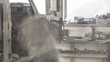 Timelapse-shot-of-car-mechanics-dismantling-a-motor-van-before-remodeling-it-inside-a-workshop