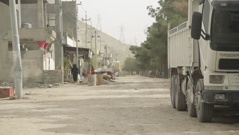 Street-in-Iraq.-Women-in-hijab-rushing-home