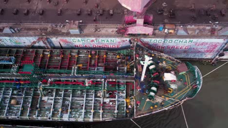 Shipyard-and-dry-dock-facility-Saigon-river-Vietnam-tracking-shot-over-large-tanker-being-repaired