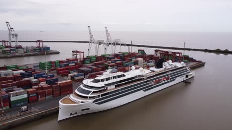 Large-cruise-ship-moored-at-industry-port,-Argentina,-aerial-parallax