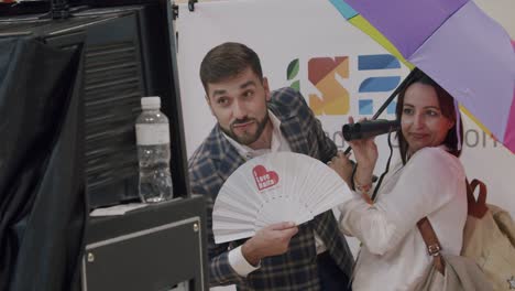 Coworkers-posing-for-photo-booth-at-trade-show,-with-props,-FITUR