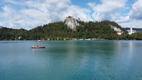 Drohnenaufnahme-Des-Bleder-Sees-In-Slowenien---Drohne-Fliegt-Tief-über-Den-See,-Vorbei-An-Einem-Ruderboot