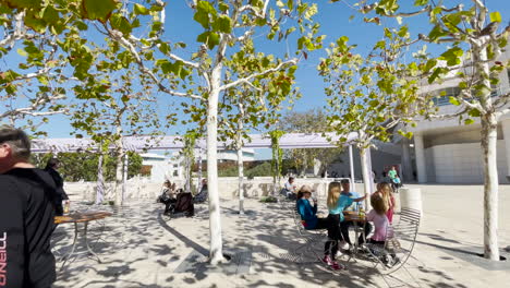 People-sit-outdoors-under-trees-at-the-famous-Getty-Center-in-Los-Angeles