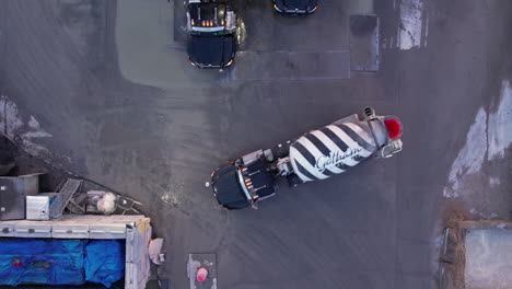 Top-Down-Aerial-View-of-Heavy-Mixer-Trucks-in-Concrete-Ready-Mix-Plant,-High-Angle-Drone-Shot-60fps