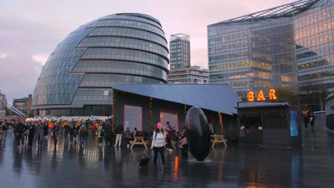 People-Walking-On-Wet-Ground-At-The-Queen's-Walk-On-River-Thames-South-Bank-In-London