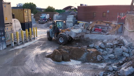 Aerial-View-of-Tracked-Loader-Machine-Lifting-Stone,-Preparing-For-Batching-in-Concrete-Ready-Mix-Plant,-Drone-Shot-60fps