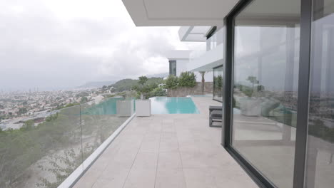 Tilt-Down-POV-Walking-Towards-Outdoor-Swimming-Pool-At-Modern-Villa-Overlooking-Calp-In-Spain