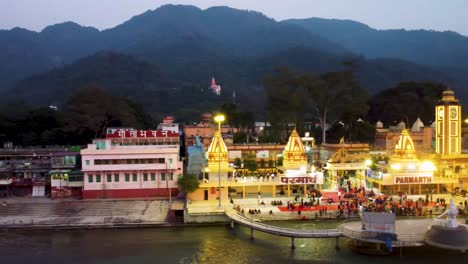 La-Orilla-Del-Río-Sagrado-Ganges-Llena-De-Templos-Religiosos-Al-Atardecer-Se-Toma-Un-Video-Aéreo-En-Parmarth-Niketan-Rishikesh-Uttrakhand-India-El-15-De-Marzo-De-2022