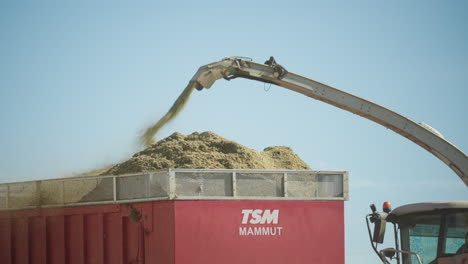 Combine-Harvester-Pouring-Grain-Into-A-Truck-In-Rhön-Grabfeld,-Germany