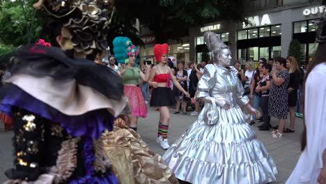 Beautiful-Carnival-costumes-worn-by-people-walking-on-city-street,-colorful-dresses