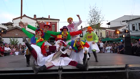 Circus-clowns-with-colorful-costumes-and-red-ball-nose-performing-on-Carnival-day