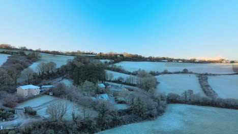 Shadow-over-frozen-hill-and-farms-with-light-horizon-from-a-rising-sun-in-Ireland