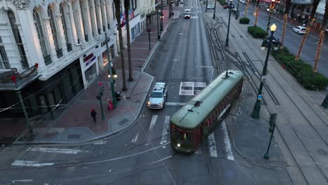 Historic-green-street-car-in-New-Orleans-turns-corner-past-Rubensteins-Mens-Store