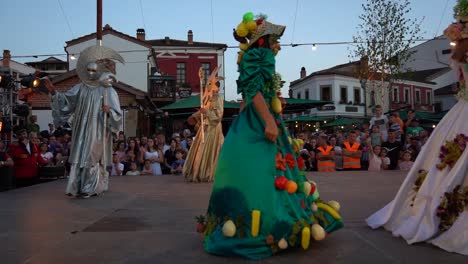 Carnival-beautiful-costumes-on-a-festive-day-performing-on-stage-in-front-of-people-crowd