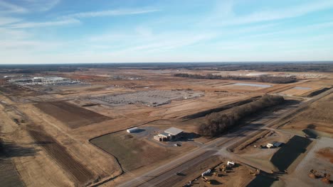 Slow-aerial-zoom-out-of-sprawling-construction-and-blue-skies