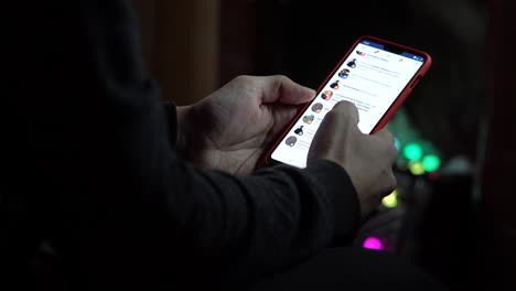 Feb-2019-Man-checking-his-facebook-profile-from-his-smartphone-with-notch