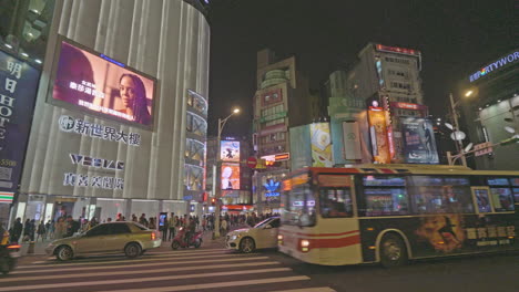 Pan-right-across-night-traffic-in-down-town-Taipei