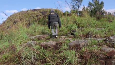 Man-running-and-jumping-up-a-rocky-hill