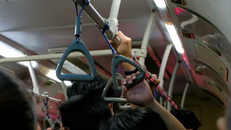 Commuters-Hands-Holding-On-To-Train-Handrail,-CLOSE-UP