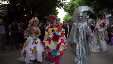 Masquerade-on-city-street-with-colorful-costumes-on-Carnival-festive-day,-slow-motion