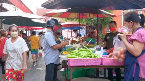 Man-Wearing-Surgical-Mask-Buys-Vegetables-From-Street-Food-Market