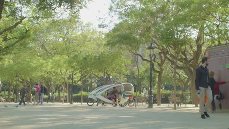 Tourists-Walking-In-A-Park-Of-Barcelona-Spain